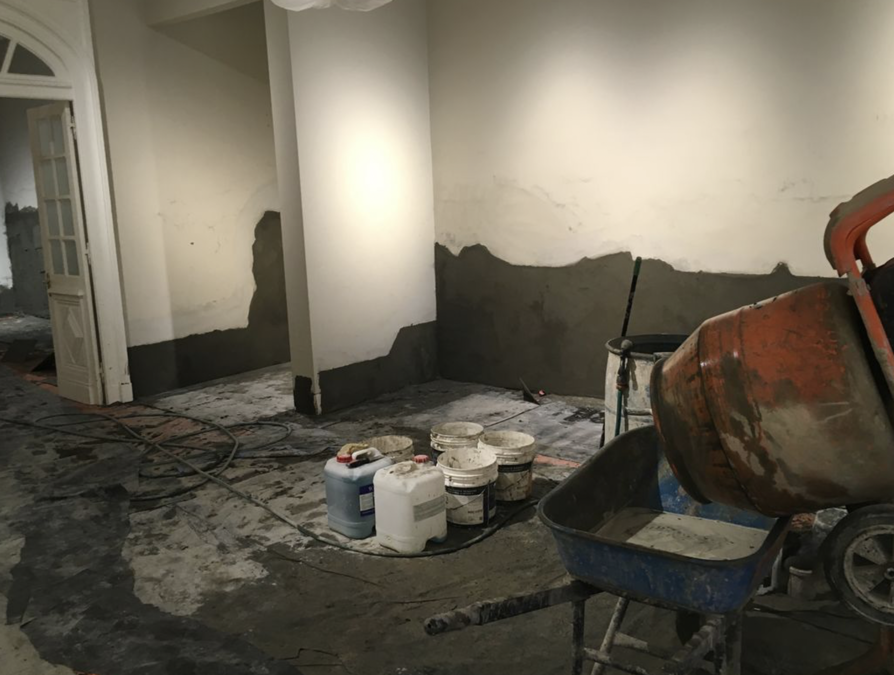 Interior wall being re-rendered after rising damp treatment